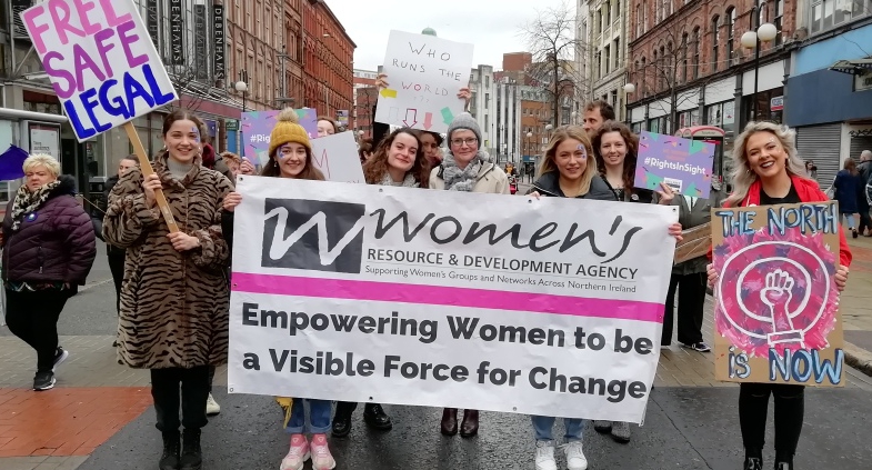 Women holding the WRDA banner.