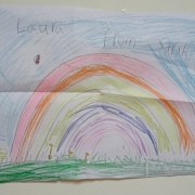 A rainbow drawn in crayon.